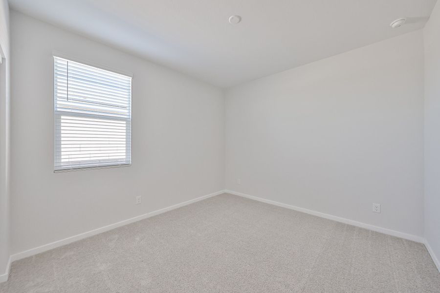 A room with a window and a carpet. A room with a window and a carpet.