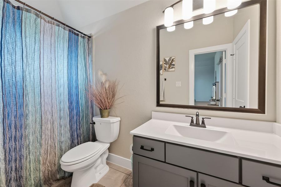 a full jack and jill style bathroom connecting 2 secondary bedrooms