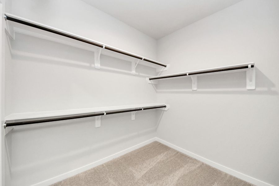 Walk-in closet that epitomizes luxury and practicality. This generously sized space features built-in shelving, offering abundant room for impeccable organization. High ceilings and recessed lighting create a bright and welcoming ambiance.