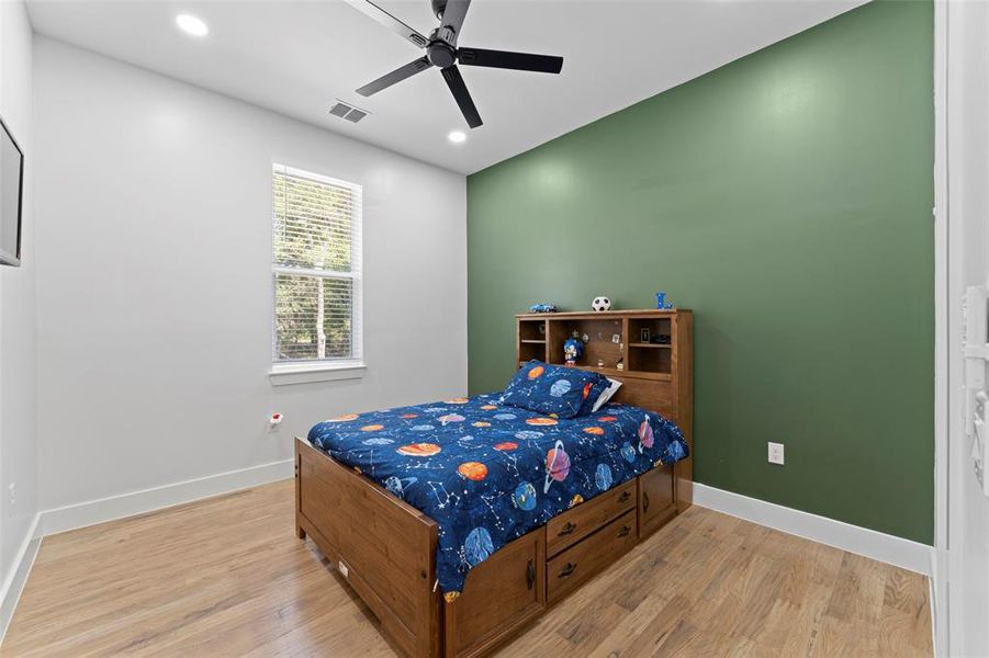 Bedroom featuring light wood-style flooring, a ceiling fan, and recessed lighting Bedroom featuring light wood-style flooring, a ceiling fan, and recessed lighting