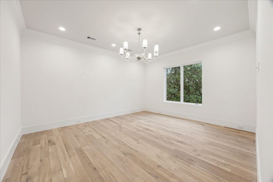The Primary Suite is adorned with 10-foot ceilings and a designer light fixture. Exquisite Legno Bastone European White Oak wood floors continue in this space adding to its overall elegance and charm.
