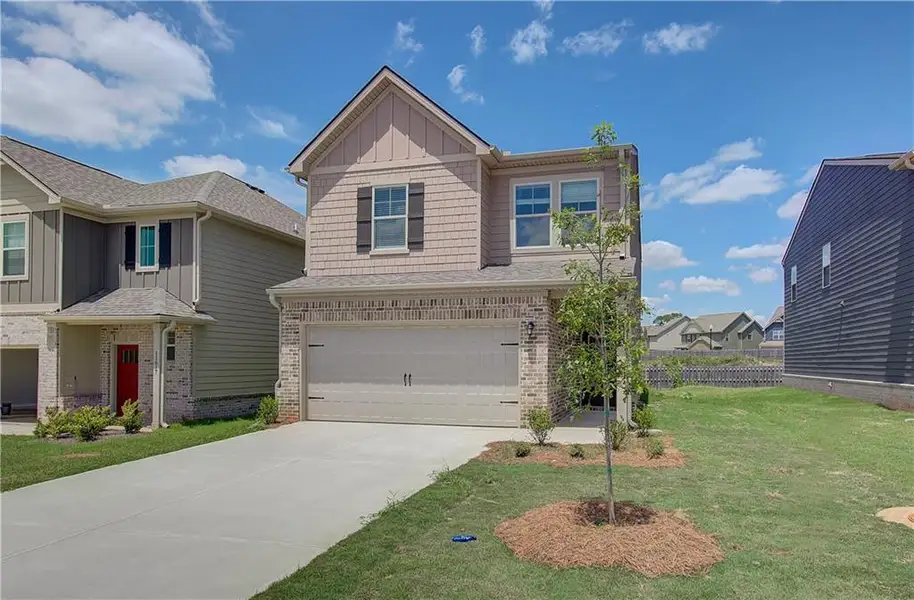 Front exterior of a new home in Towne Center, Hampton, GA, highlighting curb appeal (Image 2). Front exterior of a new home in Towne Center, Hampton, GA, highlighting curb appeal (Image 2).