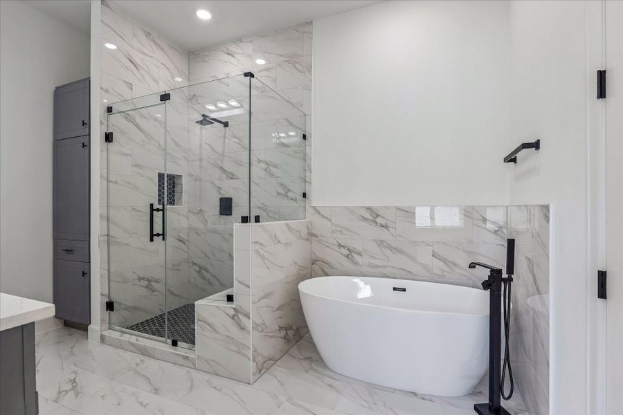 A luxurious soaking tub, and an expansive, fully tiled layout adorned with premium finishes. Modern fixtures and meticulous design elevate the space, creating a spa-like retreat that seamlessly blends style, comfort, and functionality. A luxurious soaking tub, and an expansive, fully tiled layout adorned with premium finishes. Modern fixtures and meticulous design elevate the space, creating a spa-like retreat that seamlessly blends style, comfort, and functionality.