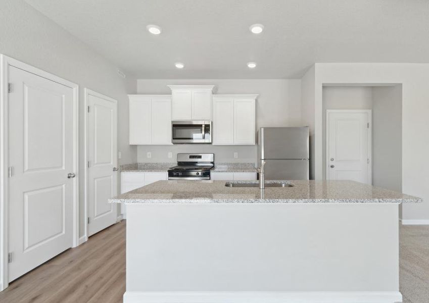 The kitchen of the Platte has beautiful white wood cabinets.