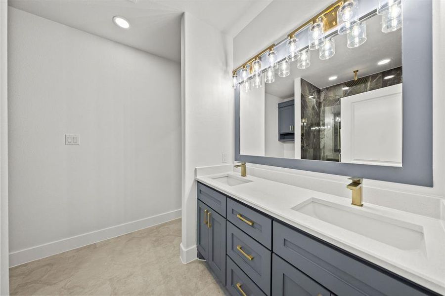 Bathroom featuring double vanity, a shower stall, and recessed lighting Bathroom featuring double vanity, a shower stall, and recessed lighting