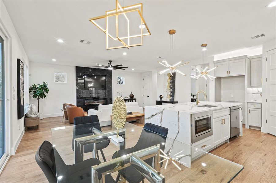 Dining space featuring recessed lighting, baseboards, visible vents, and light wood finished floors