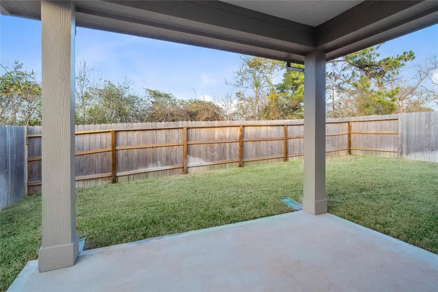 Enjoy the outdoors! A covered patio with integrated recessed lighting offers a space for entertaining guests or relaxing.