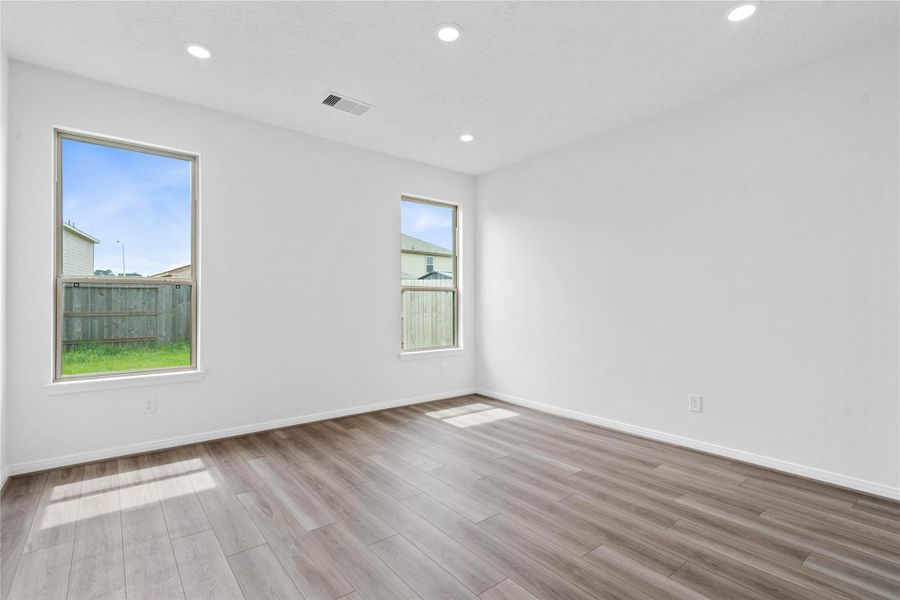 Unwind in your private sanctuary. This tranquil primary suite is a true retreat, offering a sense of calm and luxury. With vinyl plank flooring, walk-in closet, and en-suite bath, it's the perfect place to start and end your day.