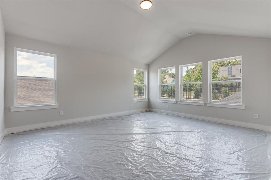 Unfurnished room with vaulted ceiling