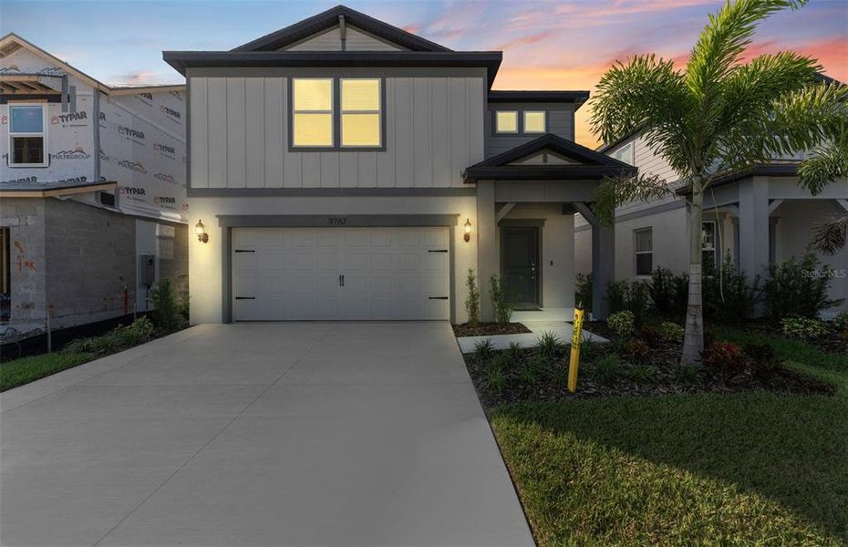 Front exterior of a new home in Spencer Glen, Riverview, FL, highlighting curb appeal (Image 1).