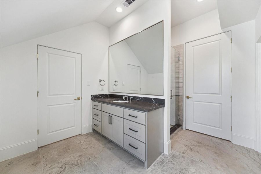 Vanity area with storage and oversized mirror for the third floor.