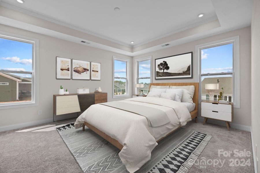 VIRTUALLY STAGED - Gorgeous Primary bedroom with tray ceiling, neutral paint and carpet and the gorgeous windows that this builder is known for.