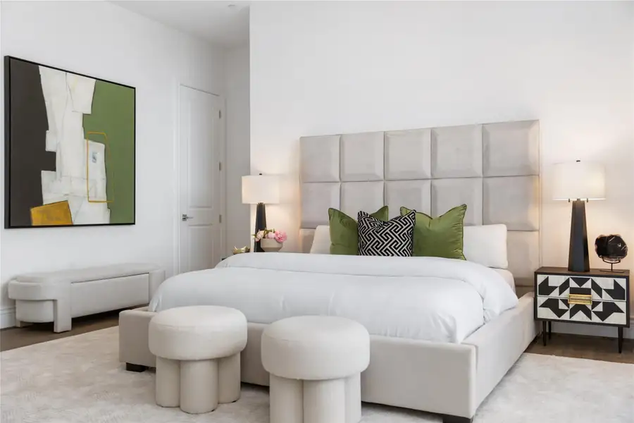 A spacious and well-appointed primary bedroom features high ceilings, a generous layout, and a calming ambiance, ideal for rest and relaxation.