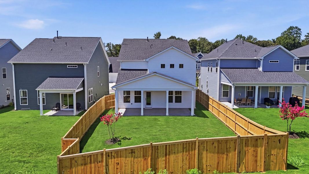 Refined rear exterior with a stylish covered porch for dining, relaxing, or entertaining at Harrier Point Refined rear exterior with a stylish covered porch for dining, relaxing, or entertaining at Harrier Point