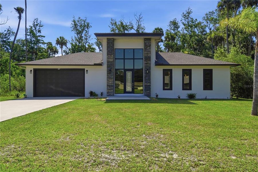 Front exterior of a new home in , Palm Coast, FL, highlighting curb appeal (Image 22). Front exterior of a new home in , Palm Coast, FL, highlighting curb appeal (Image 22).