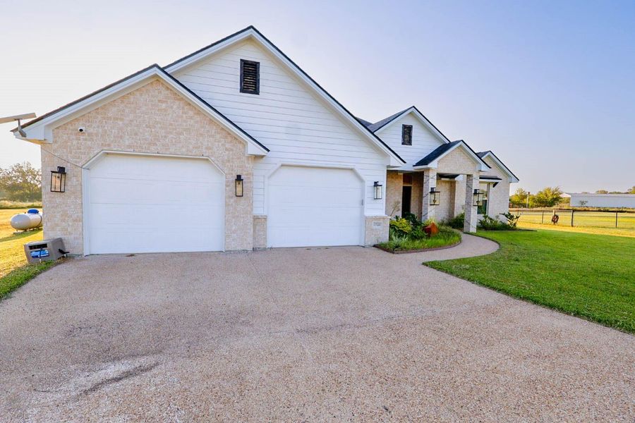 Front exterior of a new home in , Bryan, TX, highlighting curb appeal (Image 2).