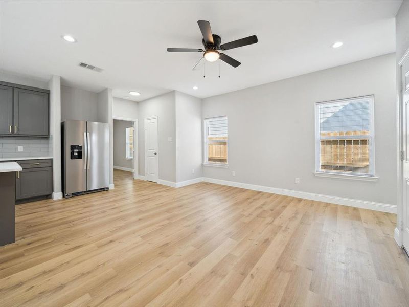 Unfurnished living room with ceiling fan and light hardwood / wood-style floors