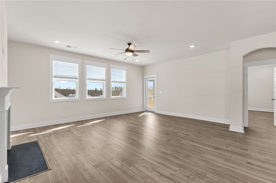 This airy living space features warm flooring, abu