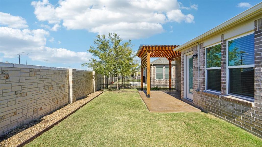 Fenced backyard featuring a pergola and a patio Fenced backyard featuring a pergola and a patio