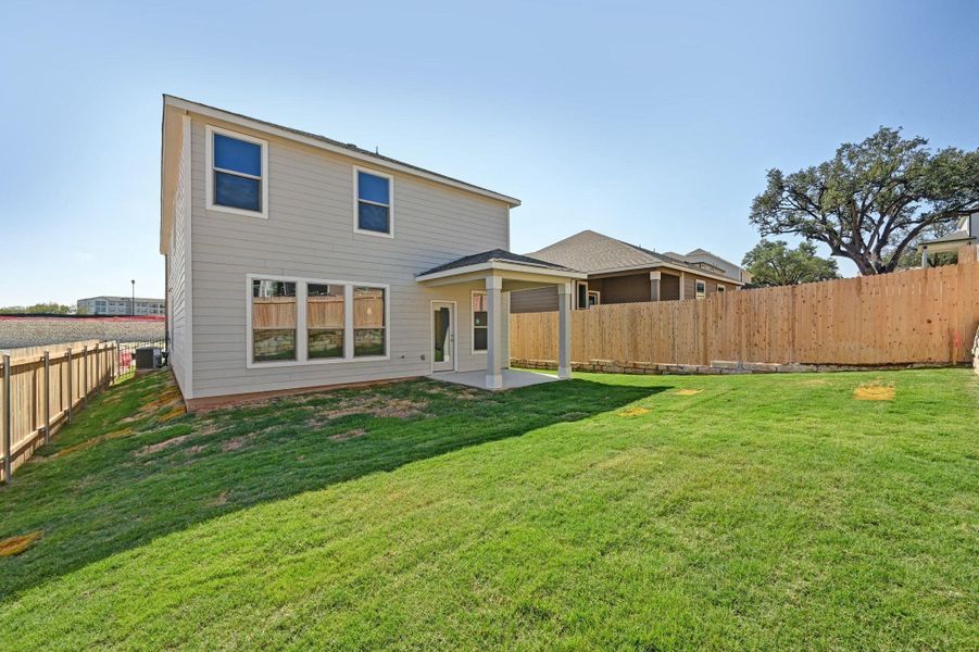 Exterior details and patio area of a home in Creekside at Estancia, Austin (Image 19).