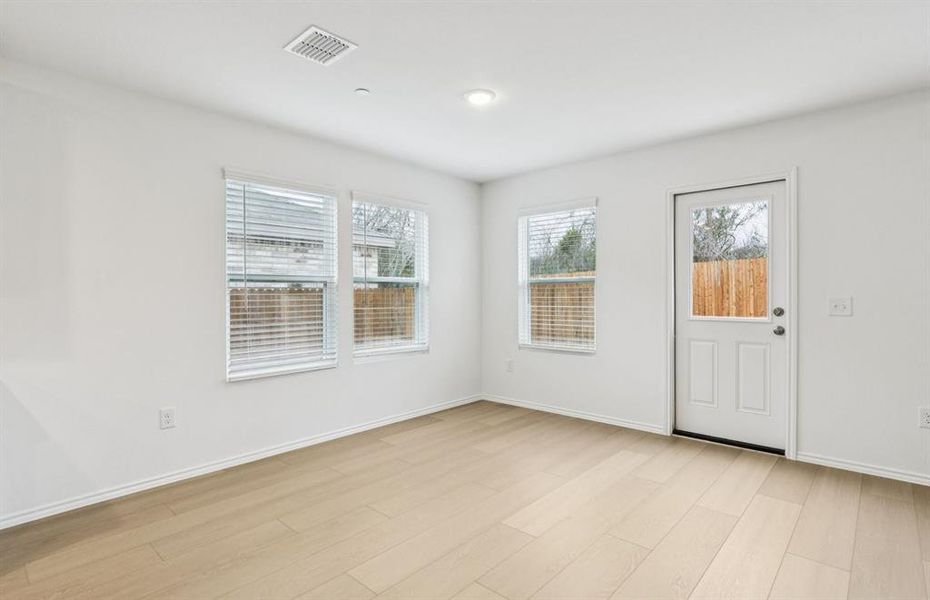 Dining nook off kitchen with large windows