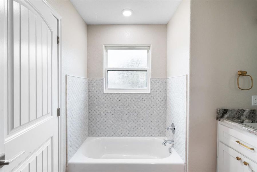 Bathroom with a washtub and vanity Bathroom with a washtub and vanity