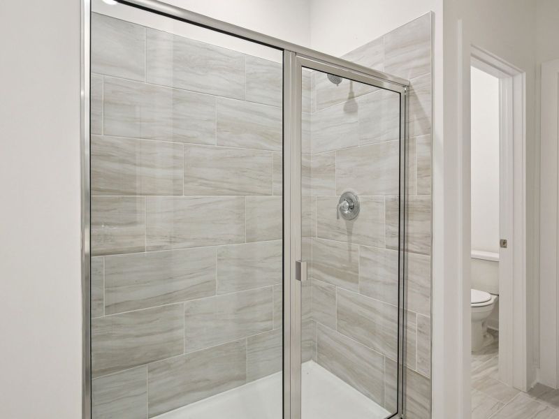 The primary bathroom offers dual vanity sinks and a walk-in shower.