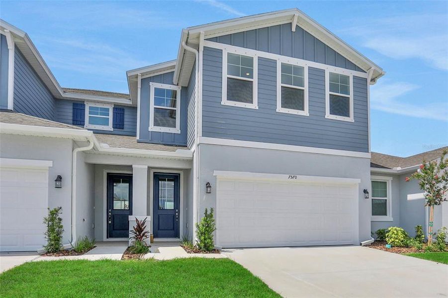 Front exterior of a new home in Seaire, Parrish, FL, highlighting curb appeal (Image 20).