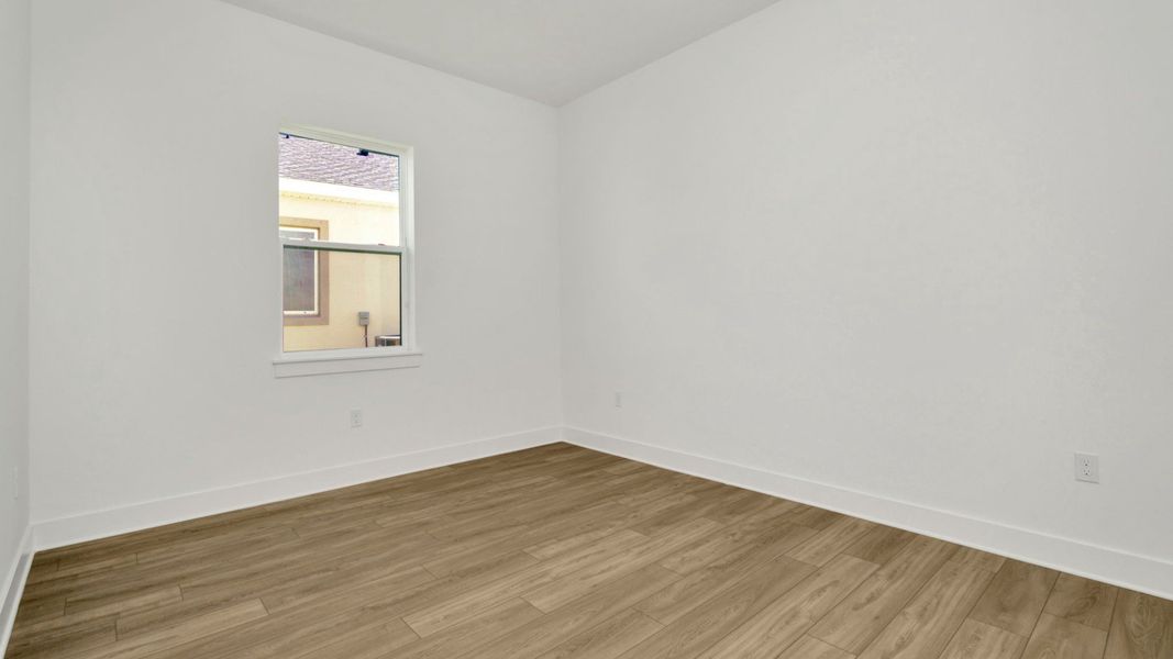 The Third Bedroom of a DRB Homes Grand Hawk which is offered as a home plan at Serengeti in Spring Hill, FL.