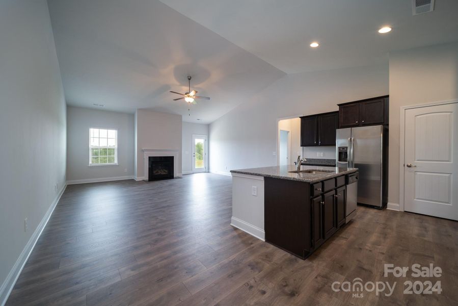 Kitchen into Family Room. Photo representation. Colors and options will differ.