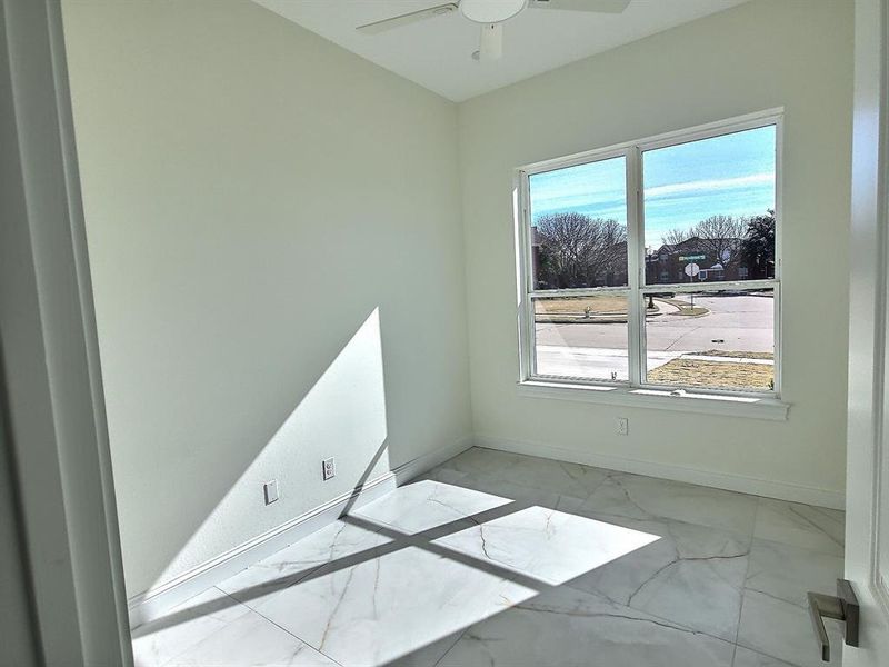 Office or Flex room featuring ceiling fan and plenty of natural light