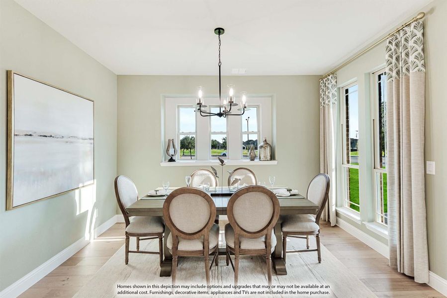 Dining room with rectangular wood table, six upholstered chairs, chandelier, and large windows with natural light.
