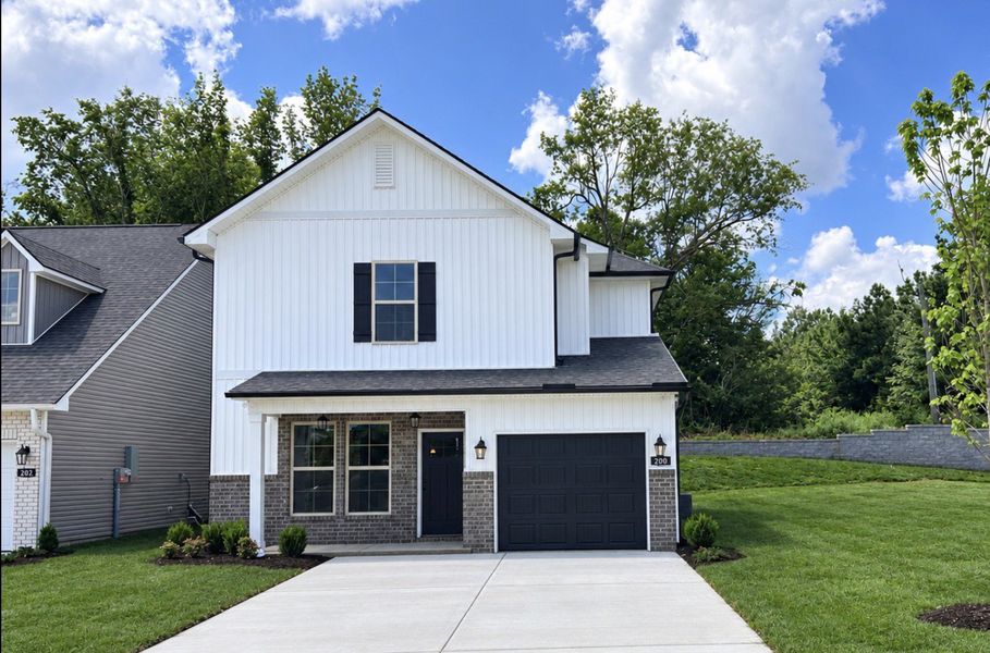 Front exterior of a new home in Hickory Cove, Burns, TN, highlighting curb appeal (Image 2). Front exterior of a new home in Hickory Cove, Burns, TN, highlighting curb appeal (Image 2).