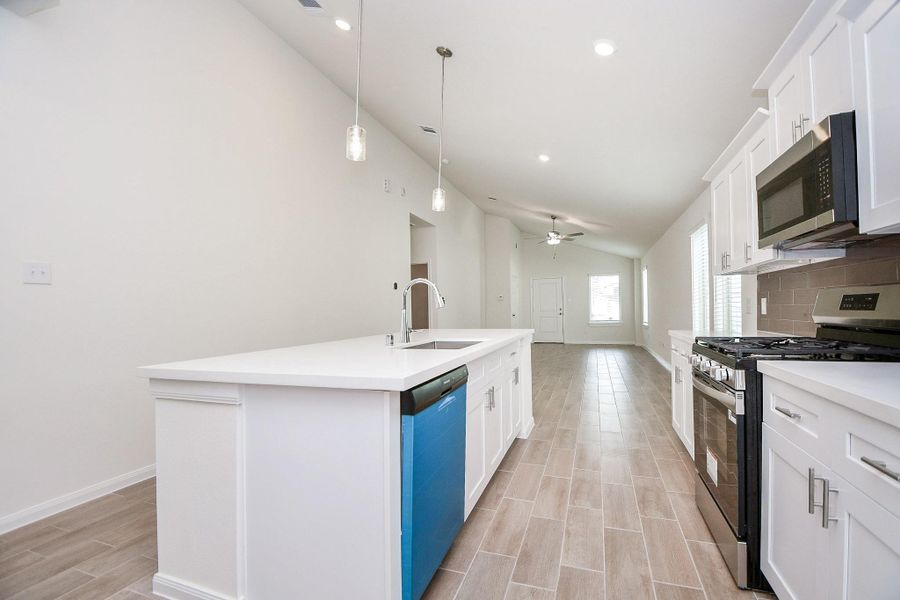 The kitchen provides a perfect amount of space to walk through and perfect to hosts guests and family gatherings.