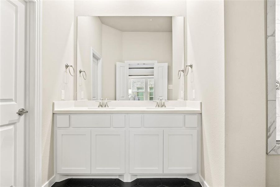 Bathroom with tile floors and dual bowl vanity