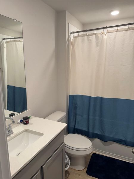 Bathroom featuring vanity, light wood-style floors, and shower / tub combo