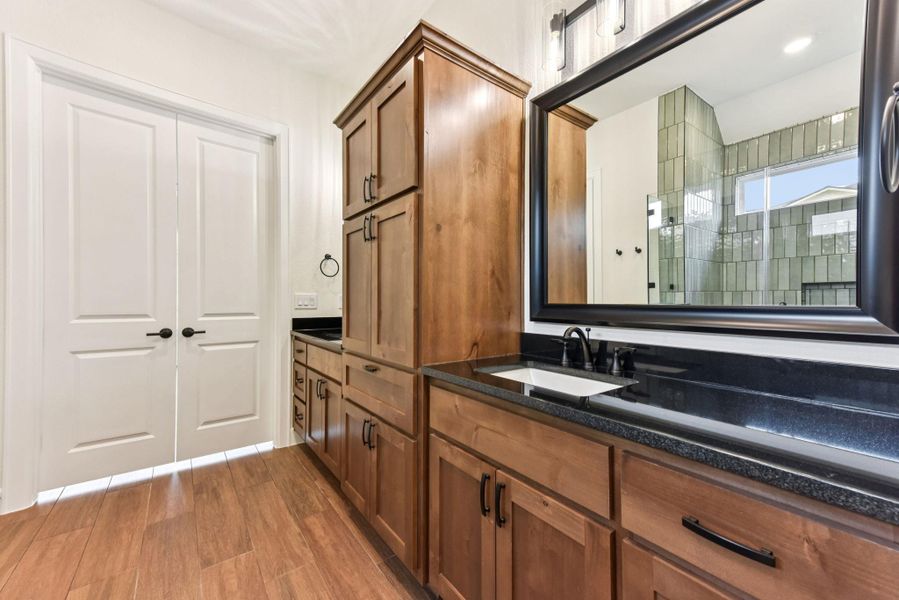 Full bathroom featuring vanity and light wood-type flooring