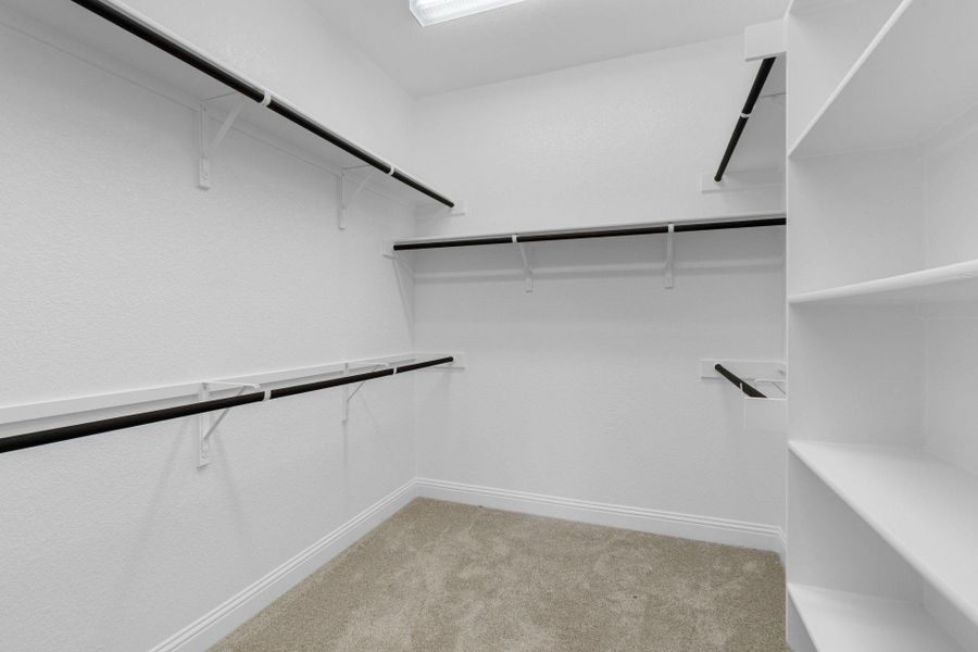 Walk-in closet in Primary Bedroom Walk-in closet in Primary Bedroom