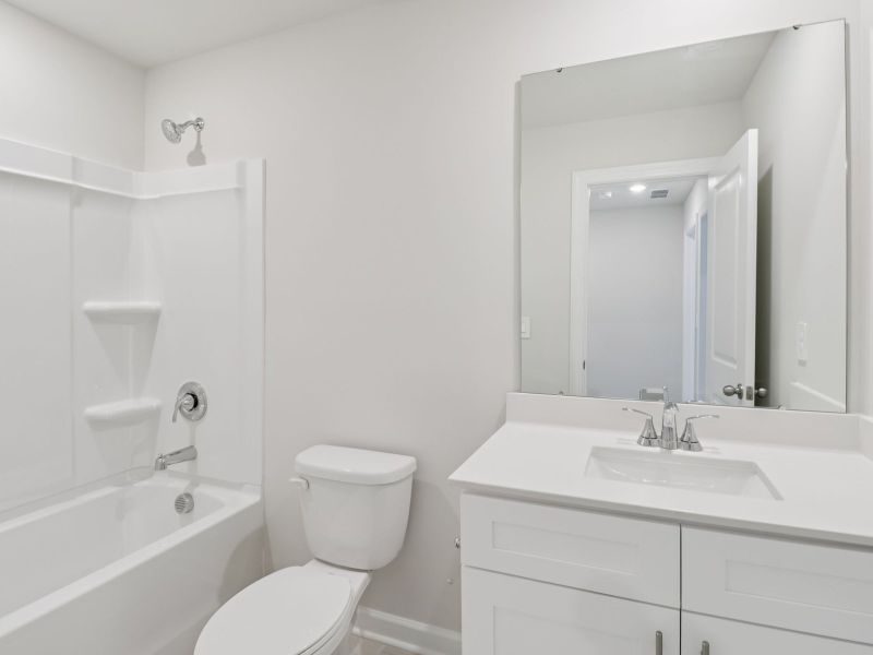 The secondary bathroom features a spacious vanity and oversized shower tub. The secondary bathroom features a spacious vanity and oversized shower tub.
