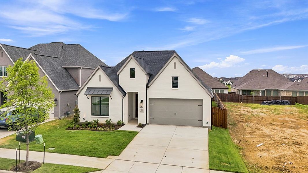 Front exterior of a new home in Tavolo Park, Fort Worth, TX, highlighting curb appeal (Image 23).