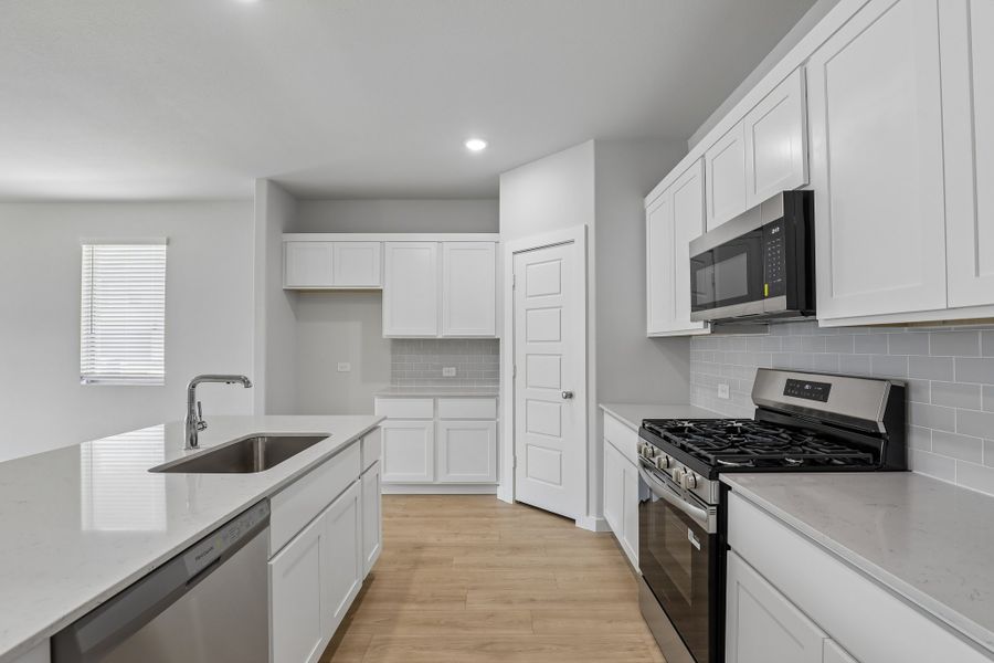 Kitchen in the Holden home plan by Trophy Signature Homes