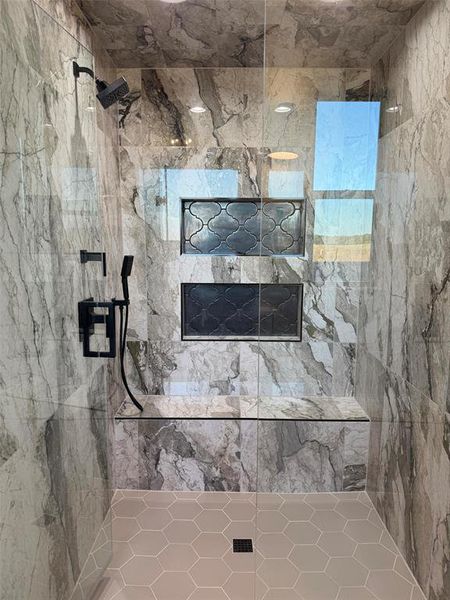 Bathroom featuring a marble finish shower Bathroom featuring a marble finish shower