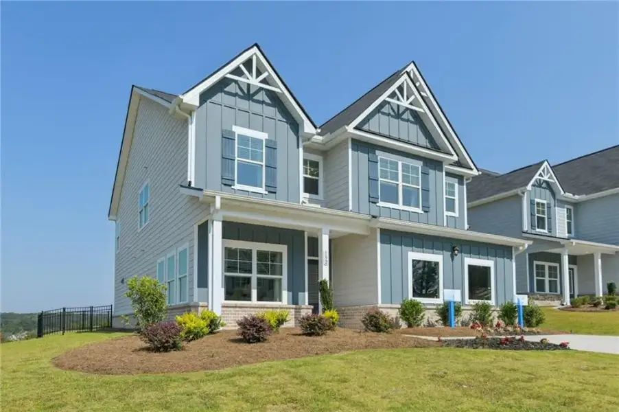 Front exterior of a new home in The Hills at Cedar Creek, Winder, GA, highlighting curb appeal (Image 19).