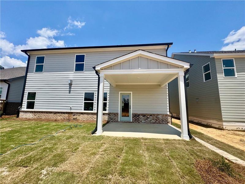 Exterior details and patio area of a home in Eastlyn Crossing, Flowery Branch (Image 8).