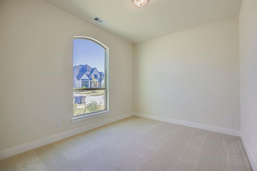 Unfurnished room featuring light carpet and baseboards Unfurnished room featuring light carpet and baseboards