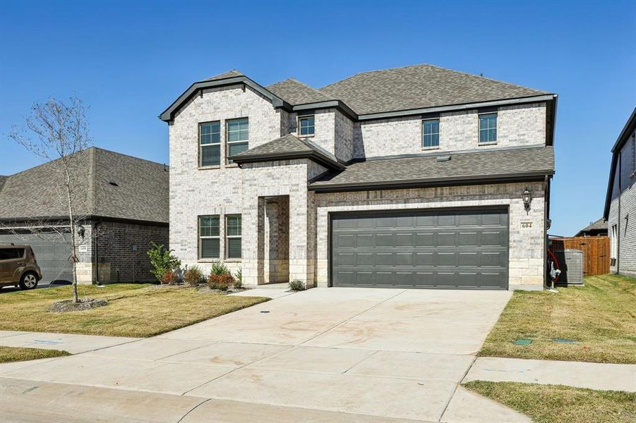 Front exterior of a new home in Southridge - Signature Series, McKinney, TX, highlighting curb appeal (Image 1). Front exterior of a new home in Southridge - Signature Series, McKinney, TX, highlighting curb appeal (Image 1).