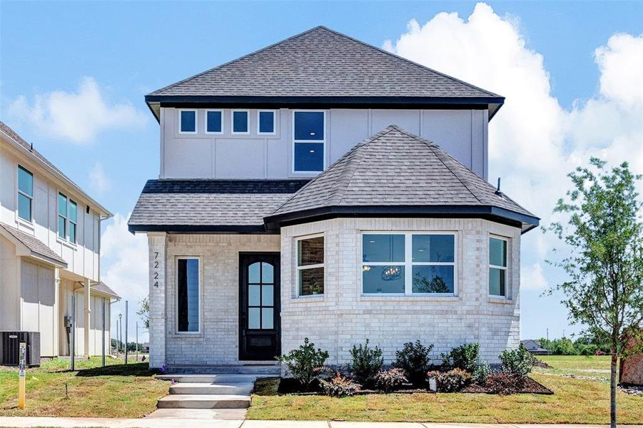 View of front of property with cooling unit and a front yard