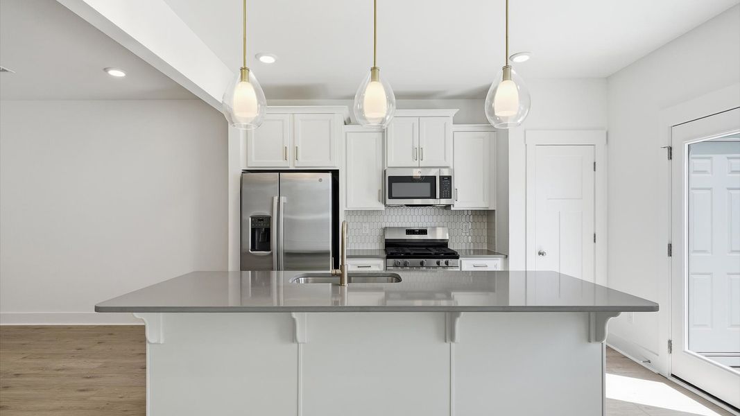 Elegant and compact island anchors this tasteful kitchen with high standards and timeless appeal at Barton Hollow Elegant and compact island anchors this tasteful kitchen with high standards and timeless appeal at Barton Hollow