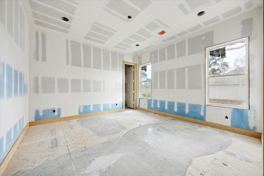 A generously sized secondary bedroom offers a bright, comfortable layout with windows positioned for natural light and privacy.