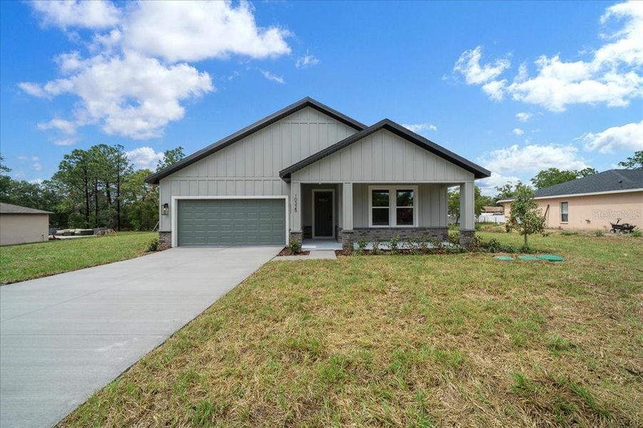 Front exterior of a new home in , Weeki Wachee, FL, highlighting curb appeal (Image 30). Front exterior of a new home in , Weeki Wachee, FL, highlighting curb appeal (Image 30).